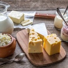 Wedge of cheese made using food-grade Calcium Chloride Powder (E509) for improved texture and curd formation.