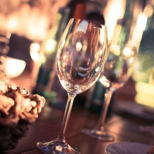 Clean wine glasses and crockery in a restaurant kitchen washed with Banquet food-safe commercial glasswashing detergent, showing sparkling results.