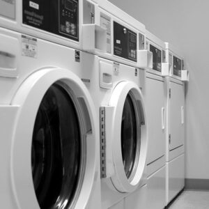 A row of washing machines designed for commercial laundry powders.